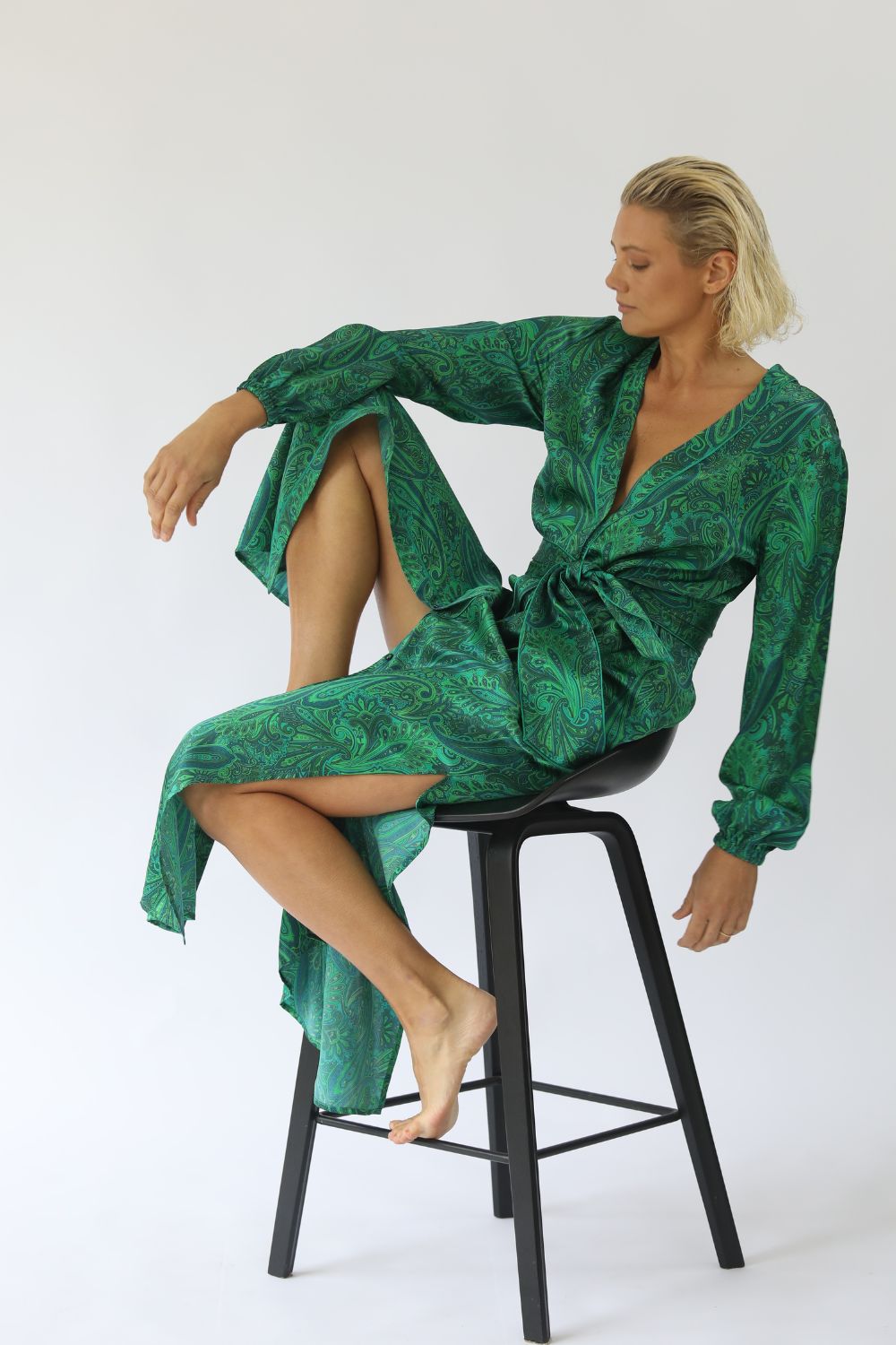 Kasana Ella Silk Dress in emerald paisley print, 100% silk satin with v-neck, button front, elasticised cuffs and matching satin belt – limited edition