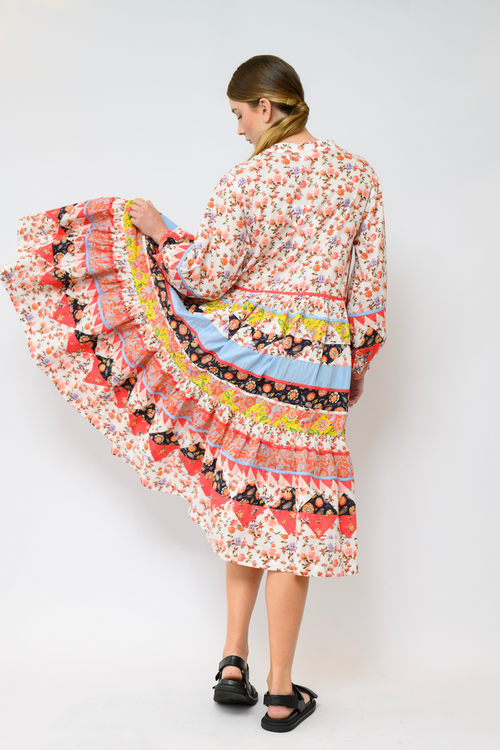 Kasana Georgie Tiered Dress on sale – 100% cotton patchwork florals in pink, lemon, coral and cornflower blue with v neck, soft billow sleeves, elasticised cuffs, and loose tiered silhouette